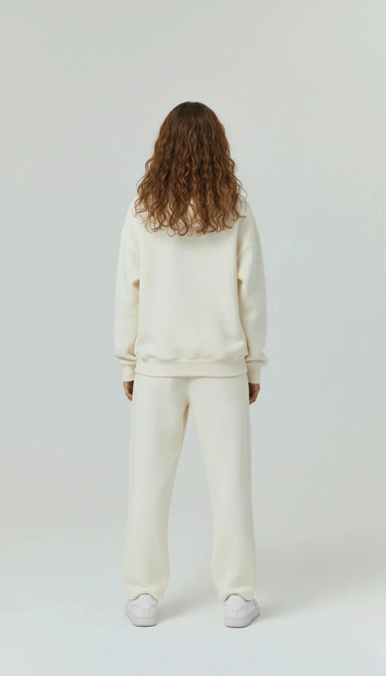 Female wearing a cream-colored -Unisex hoodie  and pant and showing backside of hoodie and white background - Mine outfit - best forfor casual wear , parties , date , university and colleges