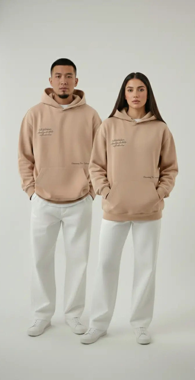 Male and female friends wearing matching beige Dune Hoodies - unisex streetwear styling idea
