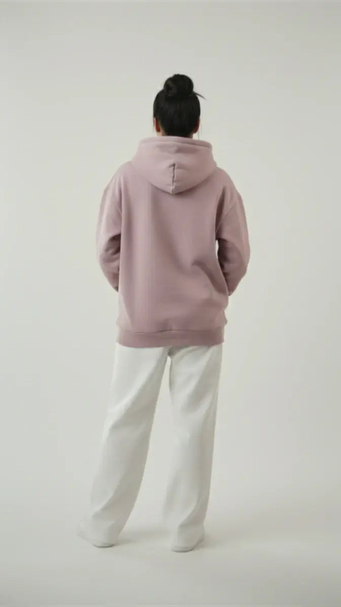 Back view of a woman modeling the Lalic lavender hoodie, showing the relaxed fit and clean design of the unisex pullover.

