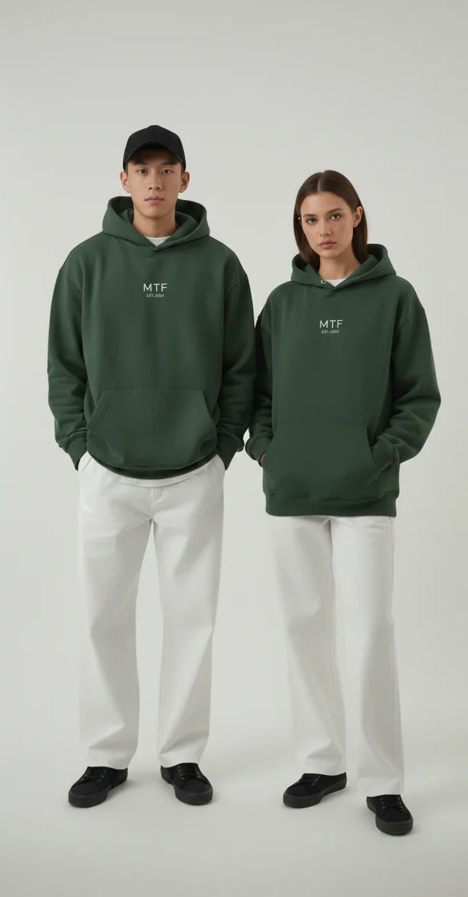 Two people wearing green hoodies with a logo on a white background